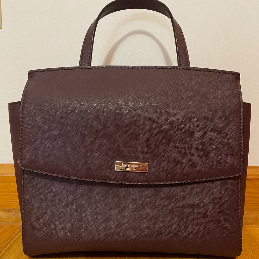 Burgundy Kate Spade satchel with adjustable shoulder strap